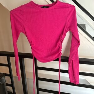 Small hot pink long sleeve tight top. Cropped. Holes on side.